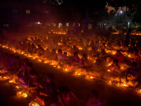 Devotees offer prayers by lighting oil lamps and incense sticks to Sri Loknath Brahmachari on the occasion of Karthik Brata at a Loknath Bra...