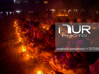 Devotees offer prayers by lighting oil lamps and incense sticks to Sri Loknath Brahmachari on the occasion of Karthik Brata at a Loknath Bra...