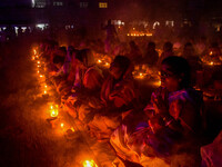 Devotees offer prayers by lighting oil lamps and incense sticks to Sri Loknath Brahmachari on the occasion of Karthik Brata at a Loknath Bra...