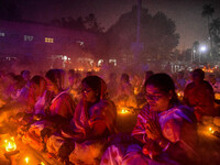 Devotees offer prayers by lighting oil lamps and incense sticks to Sri Loknath Brahmachari on the occasion of Karthik Brata at a Loknath Bra...