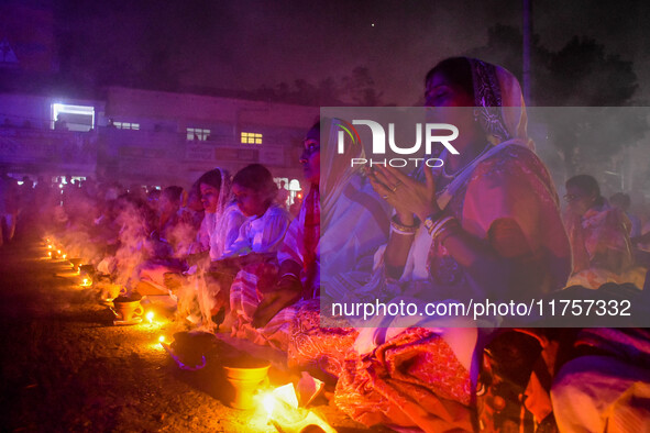 Devotees offer prayers by lighting oil lamps and incense sticks to Sri Loknath Brahmachari on the occasion of Karthik Brata at a Loknath Bra...