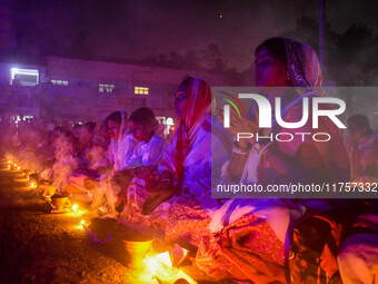 Devotees offer prayers by lighting oil lamps and incense sticks to Sri Loknath Brahmachari on the occasion of Karthik Brata at a Loknath Bra...