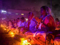 Devotees offer prayers by lighting oil lamps and incense sticks to Sri Loknath Brahmachari on the occasion of Karthik Brata at a Loknath Bra...