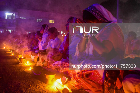 Devotees offer prayers by lighting oil lamps and incense sticks to Sri Loknath Brahmachari on the occasion of Karthik Brata at a Loknath Bra...