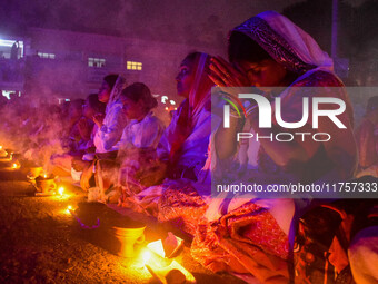 Devotees offer prayers by lighting oil lamps and incense sticks to Sri Loknath Brahmachari on the occasion of Karthik Brata at a Loknath Bra...