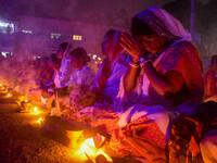 Devotees offer prayers by lighting oil lamps and incense sticks to Sri Loknath Brahmachari on the occasion of Karthik Brata at a Loknath Bra...