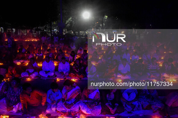 Devotees offer prayers by lighting oil lamps and incense sticks to Sri Loknath Brahmachari on the occasion of Karthik Brata at a Loknath Bra...