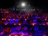 Devotees offer prayers by lighting oil lamps and incense sticks to Sri Loknath Brahmachari on the occasion of Karthik Brata at a Loknath Bra...