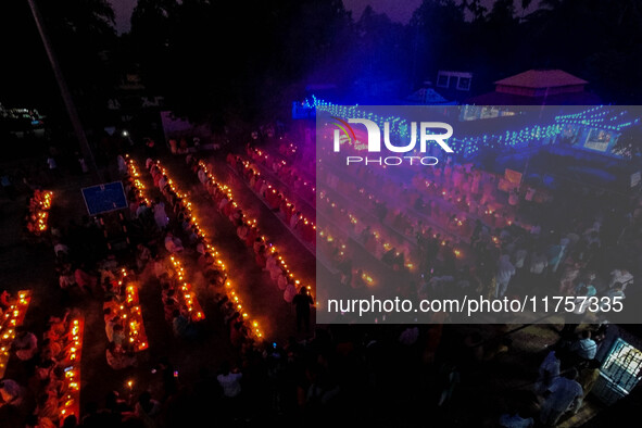 Devotees offer prayers by lighting oil lamps and incense sticks to Sri Loknath Brahmachari on the occasion of Karthik Brata at a Loknath Bra...