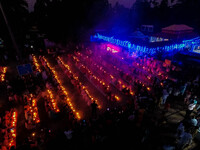 Devotees offer prayers by lighting oil lamps and incense sticks to Sri Loknath Brahmachari on the occasion of Karthik Brata at a Loknath Bra...