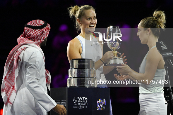 RIYADH, SAUDI ARABIA - NOVEMBER 09: Gabriela Dabrowski (R) of Canada and Erin Routliffe (C) of New Zealand receive the Trophy after winning...