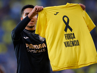 Ilias Akhomach of Villarreal CF celebrates after scoring the team's first goal and shows a t-shirt supporting the victims of the Valencia fl...