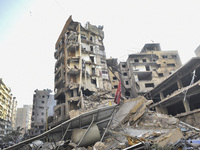 A heavily damaged building, hit by an Israeli strike, stands during a media tour organized by the Hezbollah press office to the sites of ove...