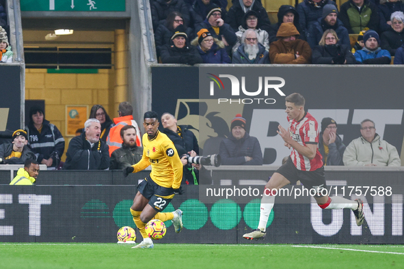 #22, Nelson Semedo of Wolves and #35, Jan Bednarek of Southampton chase after the ball during the Premier League match between Wolverhampton...