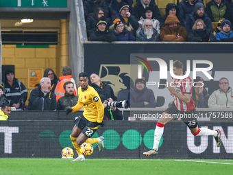 #22, Nelson Semedo of Wolves and #35, Jan Bednarek of Southampton chase after the ball during the Premier League match between Wolverhampton...