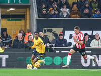 #22, Nelson Semedo of Wolves and #35, Jan Bednarek of Southampton chase after the ball during the Premier League match between Wolverhampton...