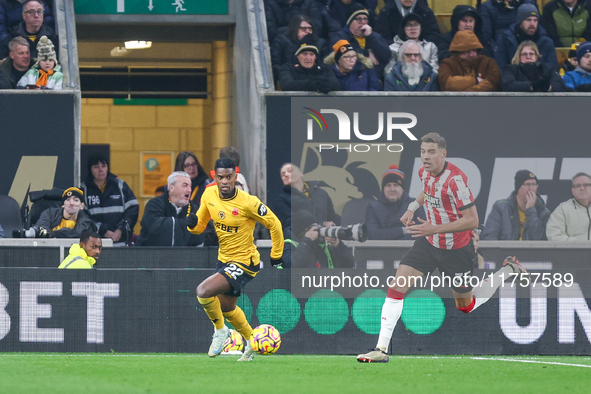 #22, Nelson Semedo of Wolves and #35, Jan Bednarek of Southampton chase after the ball during the Premier League match between Wolverhampton...