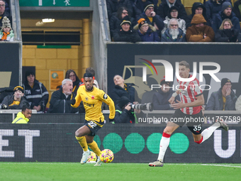 #22, Nelson Semedo of Wolves and #35, Jan Bednarek of Southampton chase after the ball during the Premier League match between Wolverhampton...