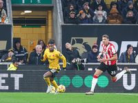 #22, Nelson Semedo of Wolves and #35, Jan Bednarek of Southampton chase after the ball during the Premier League match between Wolverhampton...