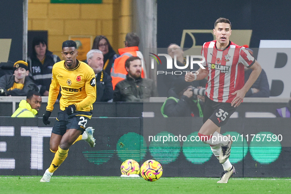 #22, Nelson Semedo of Wolves and #35, Jan Bednarek of Southampton chase after the ball during the Premier League match between Wolverhampton...