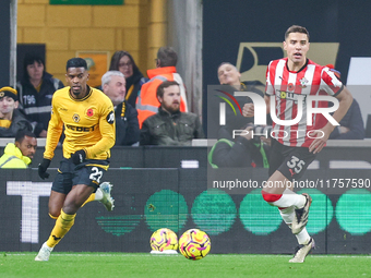 #22, Nelson Semedo of Wolves and #35, Jan Bednarek of Southampton chase after the ball during the Premier League match between Wolverhampton...