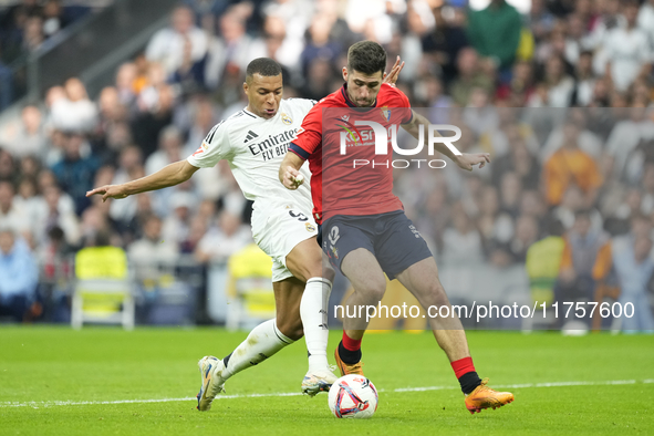 Kylian Mbappe centre-forward of Real Madrid and France and Jesus Areso right-back of Osasuna and Spain compete for the ball during the La Li...