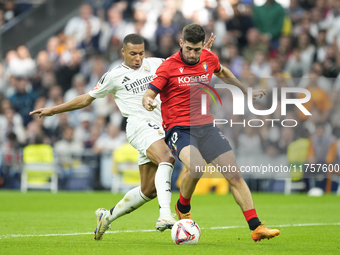 Kylian Mbappe centre-forward of Real Madrid and France and Jesus Areso right-back of Osasuna and Spain compete for the ball during the La Li...