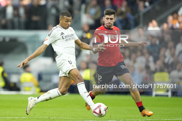 Kylian Mbappe centre-forward of Real Madrid and France and Jesus Areso right-back of Osasuna and Spain compete for the ball during the La Li...