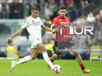 Kylian Mbappe centre-forward of Real Madrid and France and Jesus Areso right-back of Osasuna and Spain compete for the ball during the La Li...