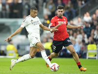 Kylian Mbappe centre-forward of Real Madrid and France and Jesus Areso right-back of Osasuna and Spain compete for the ball during the La Li...