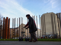 People walk by Berlin Wall remains at Berlin Wall Memorial during the 35th anniversary of the fall of the Berlin Wall. Berlin, Germany on 9...