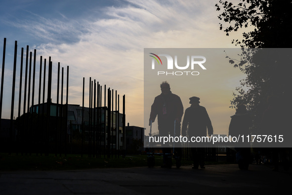 People walk by Berlin Wall remains at Berlin Wall Memorial during the 35th anniversary of the fall of the Berlin Wall. Berlin, Germany on 9...