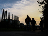 People walk by Berlin Wall remains at Berlin Wall Memorial during the 35th anniversary of the fall of the Berlin Wall. Berlin, Germany on 9...