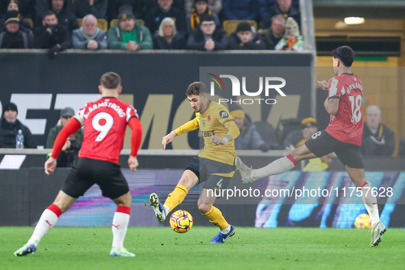 #4, Santiago Bueno of Wolves hits the ball forward under the outstretched boot of #18, Mateus Fernandes of Southampton during the Premier Le...