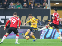 #4, Santiago Bueno of Wolves hits the ball forward under the outstretched boot of #18, Mateus Fernandes of Southampton during the Premier Le...