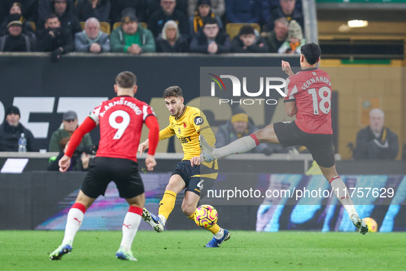 #4, Santiago Bueno of Wolves hits the ball forward under the outstretched boot of #18, Mateus Fernandes of Southampton during the Premier Le...