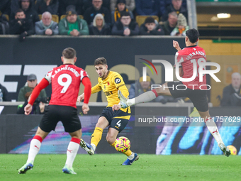 #4, Santiago Bueno of Wolves hits the ball forward under the outstretched boot of #18, Mateus Fernandes of Southampton during the Premier Le...