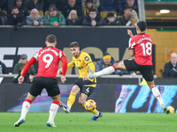 #4, Santiago Bueno of Wolves hits the ball forward under the outstretched boot of #18, Mateus Fernandes of Southampton during the Premier Le...