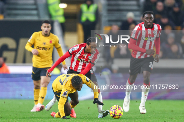 #27, Jean-Ricner Bellegarde of Wolves, is brought down by the challenge from #2, Kyle Walker-Peters of Southampton, during the Premier Leagu...