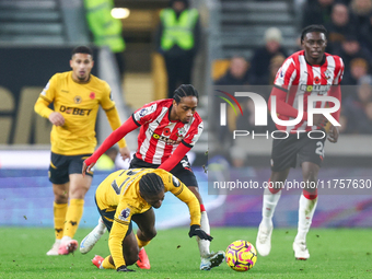 #27, Jean-Ricner Bellegarde of Wolves, is brought down by the challenge from #2, Kyle Walker-Peters of Southampton, during the Premier Leagu...