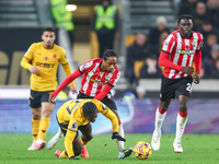 #27, Jean-Ricner Bellegarde of Wolves, is brought down by the challenge from #2, Kyle Walker-Peters of Southampton, during the Premier Leagu...