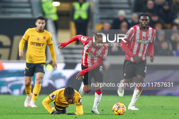 #27, Jean-Ricner Bellegarde of Wolves, is brought down by the challenge from #2, Kyle Walker-Peters of Southampton, during the Premier Leagu...