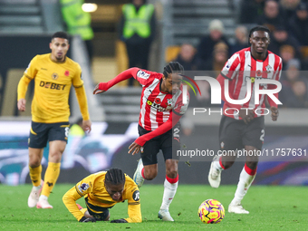 #27, Jean-Ricner Bellegarde of Wolves, is brought down by the challenge from #2, Kyle Walker-Peters of Southampton, during the Premier Leagu...