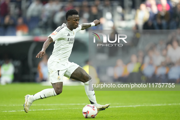 Vinicius Junior left winger of Real Madrid and Brazil in action during the La Liga match between Real Madrid CF and CA Osasuna at Estadio Sa...