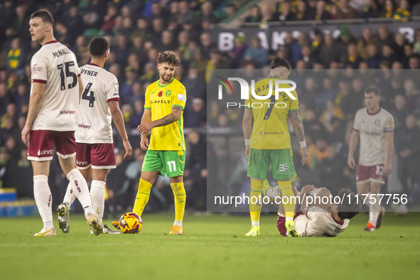 Borja Sainz of Norwich City checks on Yu Hirakawa of Bristol City after a tackle during the Sky Bet Championship match between Norwich City...