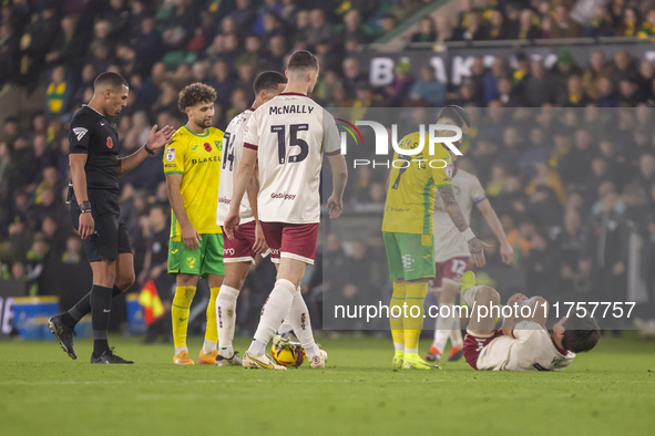 Borja Sainz of Norwich City checks on Yu Hirakawa of Bristol City after a tackle during the Sky Bet Championship match between Norwich City...