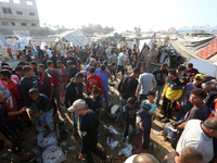 Palestinians inspect the site of an Israeli strike on a tent housing displaced people at Al-Aqsa Martyrs Hospital in Deir Al-Balah, in the c...