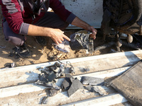 Palestinians inspect the site of an Israeli strike on a tent housing displaced people at Al-Aqsa Martyrs Hospital in Deir Al-Balah, in the c...