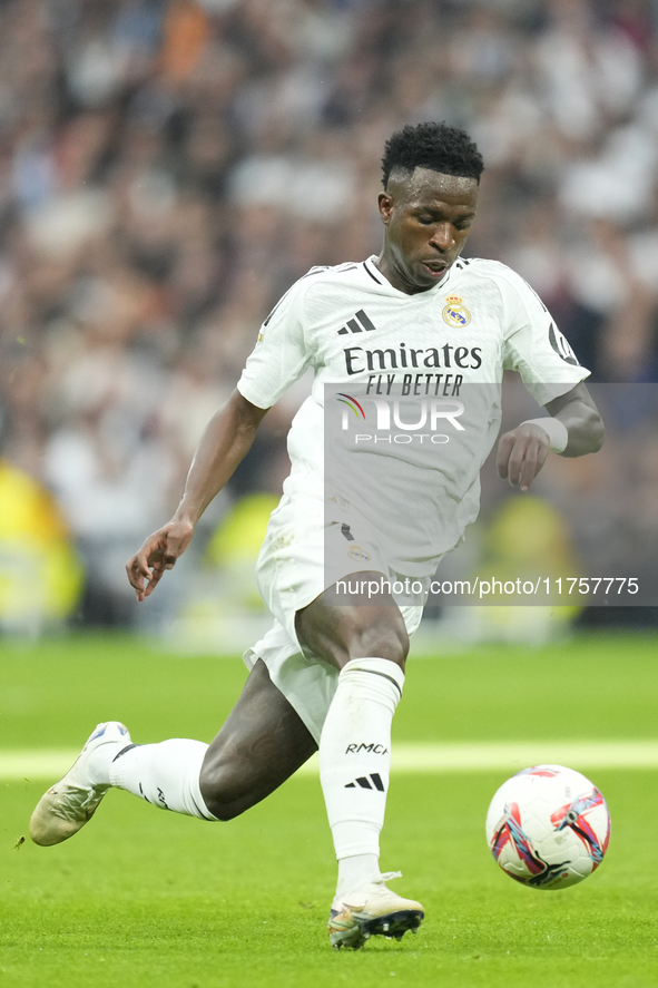 Vinicius Junior left winger of Real Madrid and Brazil in action during the La Liga match between Real Madrid CF and CA Osasuna at Estadio Sa...