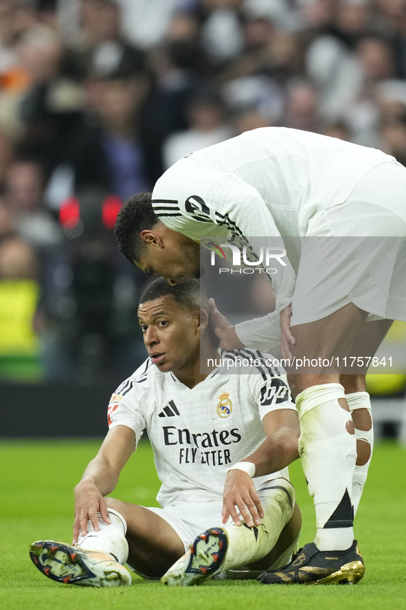 Kylian Mbappe centre-forward of Real Madrid and France is comforted by Jude Bellingham central midfield of Real Madrid and England during th...